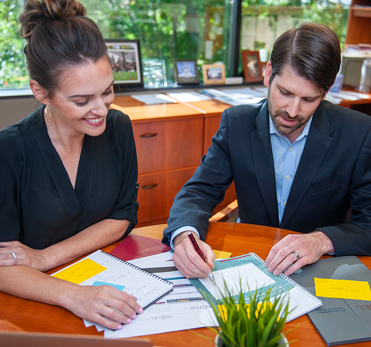 Two workers review marketing campaign at table