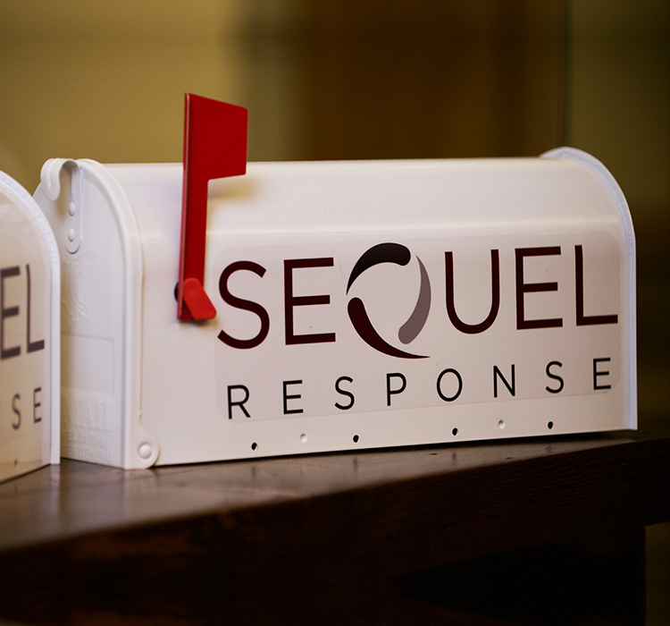 White mailbox with SeQuel Response logo